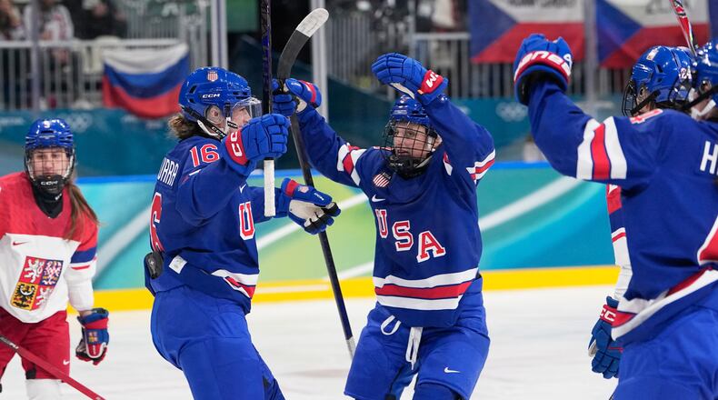 United States' Hayley Scamurra, left, celebrates with teammates after scoring her sides fifth goal during a preliminary round match of women's ice hockey between United States and Czechia at the 2026 Winter Olympics, in Milan, Italy, Thursday, Feb. 5, 2026. (AP Photo/Petr David Josek)