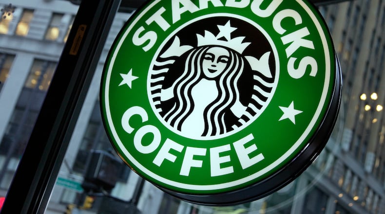 FILE - This Dec. 20, 2010 file photo shows signage at a Starbucks store in New York. (AP Photo/Richard Drew, File)