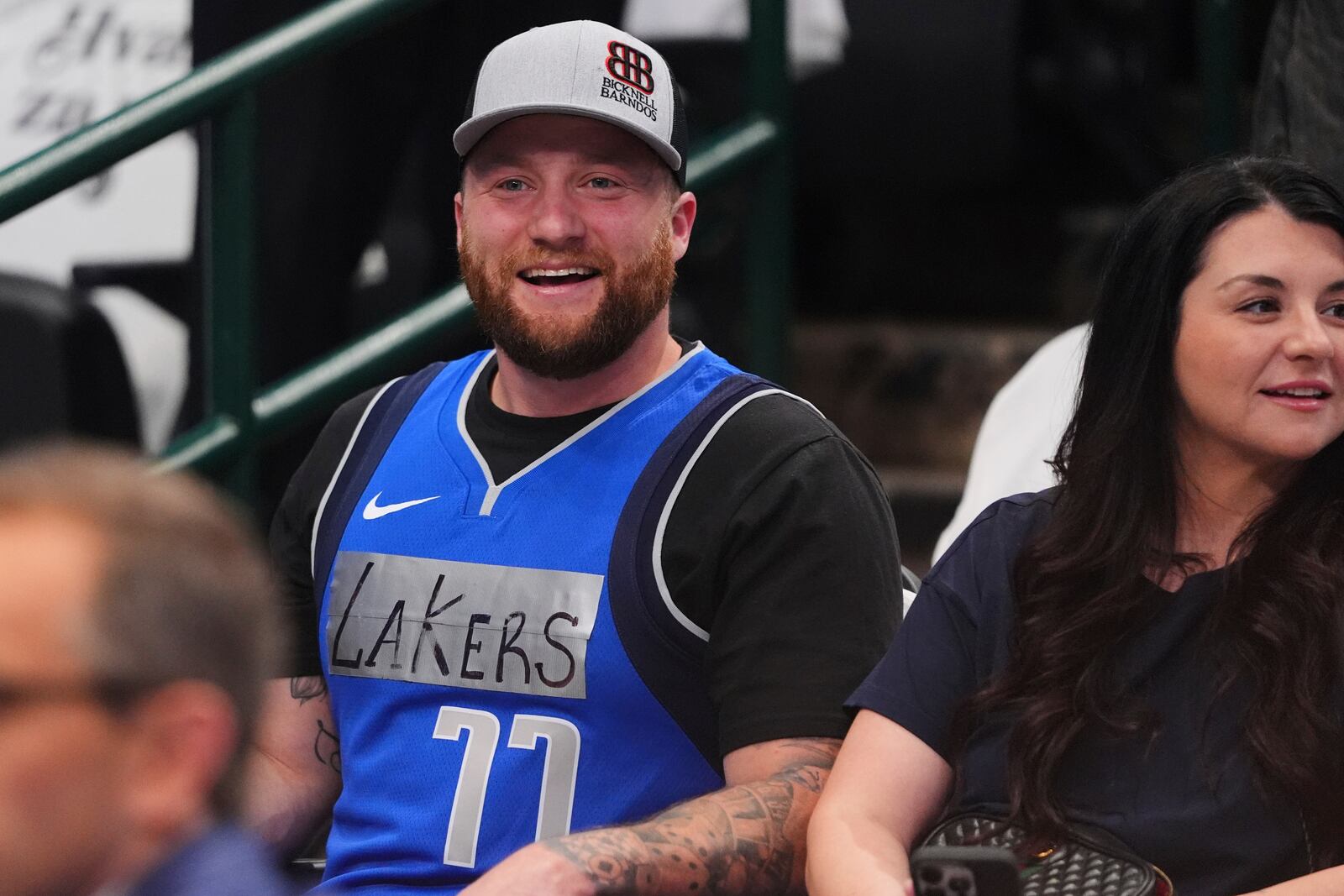 A fan wears a Dallas Mavericks jersey with tape and writing on it that reads "Lakers" and former player Luka Doncic's number on it during warmups before an NBA basketball game against the Los Angeles Lakers in Dallas, Wednesday, April 9, 2025. (AP Photo/LM Otero)