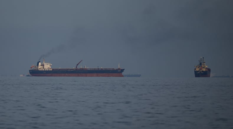 Oil tankers and cargo ships line up in the Strait of Hormuz as seen from Khor Fakkan, United Arab Emirates, Wednesday, March 11, 2026. (AP Photo/Altaf Qadri)