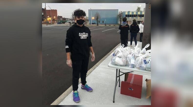 Ashtyn Bennett, of Middletown, took the $150 his parents gave him for his 14th birthday and used the money to buy food for the homeless. Ashtyn and his friends served 78 homeless meals Friday in downtown Middletown. SUBMITTED PHOTO