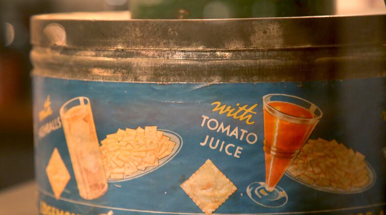 The Cheez-It cracker was invented in Dayton in 1921 by the Greene & Greene Company. This snack can, circa 1929, is on display at Carillon Historical Park.  LISA POWELL / DAYTON DAILY NEWS