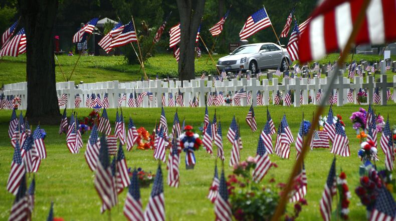 Many people around the region paid their respects to family members who has died and served in the military. Pictured are military graves at Woodside Cemetery in Middeltown. MICHAEL D. PITMAN/STAFF