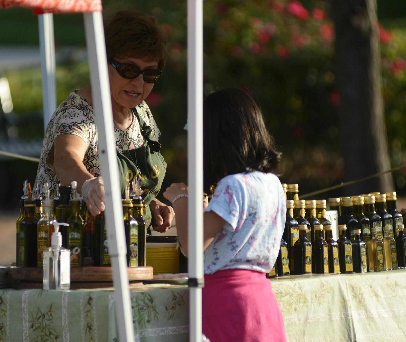 Evie Semertzides, of Mt. Kofinas Olive Oil and Vinegar, was hopeful for Fairfield’s farmers’ market and despite the attendance thinning out, remains optimistic with the efforts being made by organizers to improve the market. MICHAEL D. PITMAN/STAFF