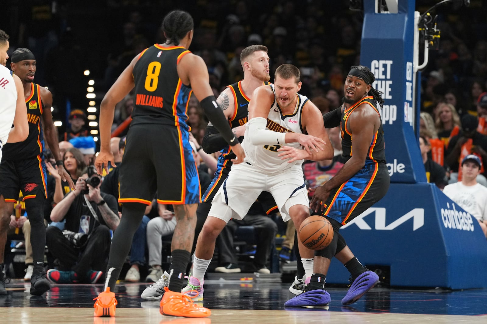 Denver Nuggets center Nikola Jokic, center, loses control of the ball as Oklahoma City Thunder's Jalen Williams (8), Isaiah Hartenstein, center rear, and Luguentz Dort, right, defend in the second half of Game 2 in the conference semifinals of the NBA basketball playoffs, Wednesday, May 7, 2025, in Oklahoma City. (AP Photo/Kyle Phillips)