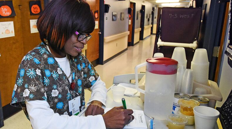 Nurse Sherrill Benndorf works in the west wing of the Butler County Care Facility Tuesday, Oct. 25 in Hamilton. Butler County Care Facility Administrator Chuck Demidovich presented the county commissioners with some new cost saving options, namely “selling” 10 bed licenses and or closing the adult daycare. Combined the county would receive a one-time windfall of $200,000 on the beds and an additional $155,000 annually. NICK GRAHAM/STAFF