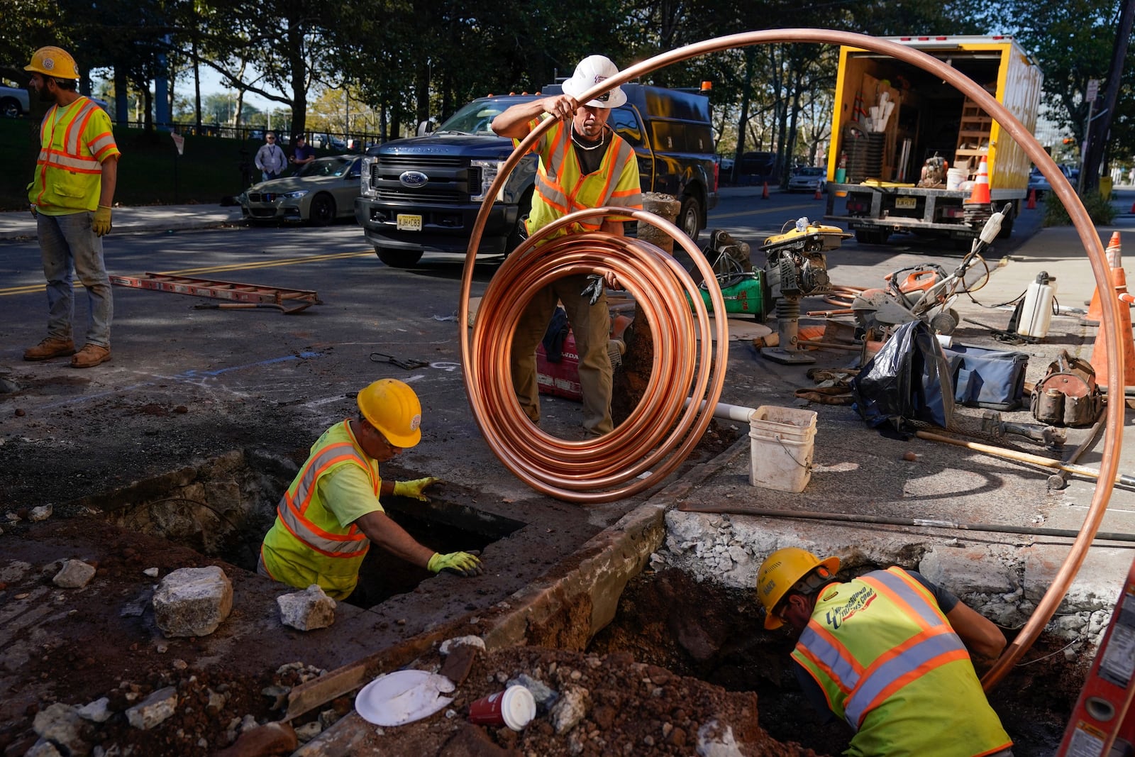 FILE - Workmen prepare to replace older water pipes with a new copper one in Newark, N.J., Oct. 21, 2021. (AP Photo/Seth Wenig, File)