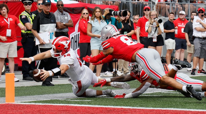 Youngstown State quarterback Beau Brungard, left, is forced out of bounds short of the goal line by Ohio State defensive back Lathan Ransom during the first half of an NCAA college football game Saturday, Sept. 9, 2023, in Columbus, Ohio. (AP Photo/Jay LaPrete)