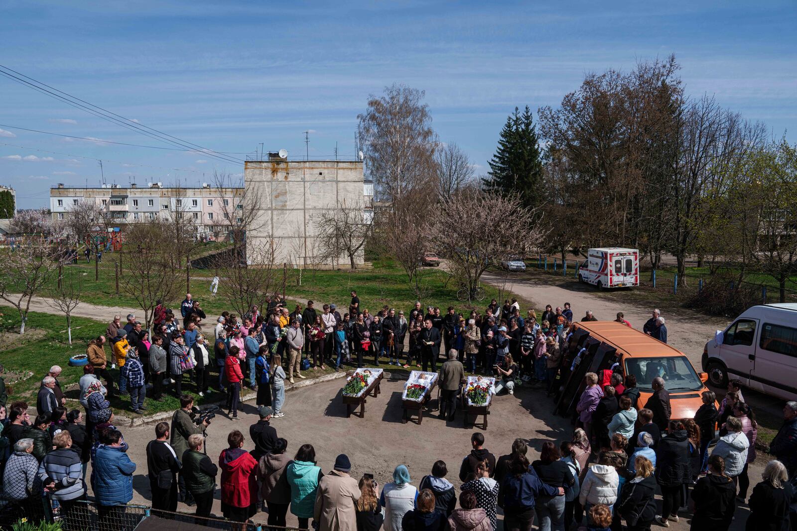 People came to say goodbye to a family of Maksym Martynenko, 11, Natalia Martynenko, 49, Mykola Martynenko, 41, which were killed in a deadly Palm Sunday Russian attack on Sumy on April 13, during farewell ceremony in Stare Selo village near Sumy, Ukraine, April 16, 2025. (AP Photo/Evgeniy Maloletka)