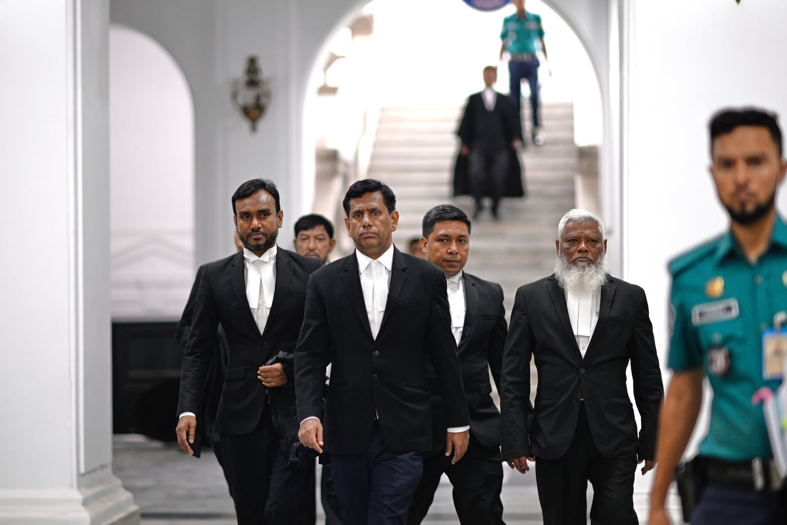 Chief Prosecutor Mohammad Tajul Islam, second left, arrives to speak to the media after a special tribunal indicted Bangladesh’s ousted Prime Minister Sheikh Hasina by accepting charges of crimes against humanity filed against her at the International Crimes Tribunal in Dhaka, Bangladesh, Thursday, July 10, 2025. (AP Photo/Mahmud Hossain Opu)