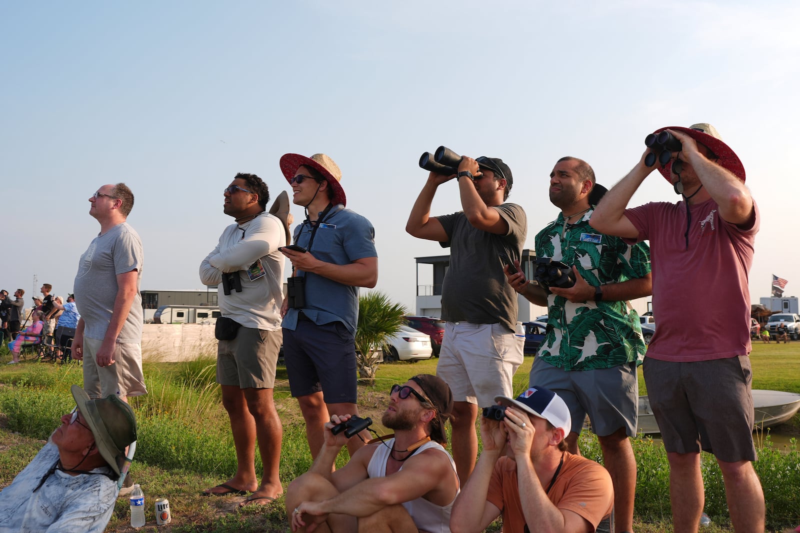 People watch as SpaceX's mega rocket Starship makes a test flight from Starbase, Texas, Tuesday, May 27, 2025. (AP Photo/Eric Gay)