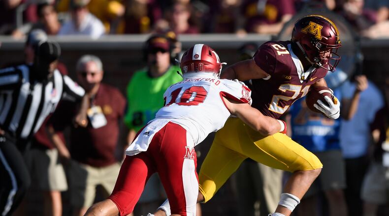 MINNEAPOLIS, MN - SEPTEMBER 15: Bryce Williams #21 of the Minnesota Golden Gophers carries the ball against Sterling Weatherford #10 of the Miami (Oh) Redhawks during the fourth quarter of the game on September 15, 2018 at TCF Bank Stadium in Minneapolis, Minnesota. The Golden Gophers defeated the Redhawks 26-3. (Photo by Hannah Foslien/Getty Images)
