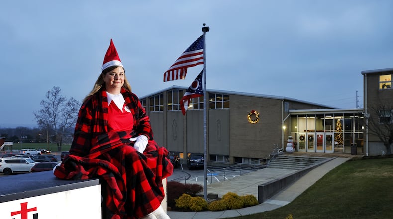 Dawn Pickerill, Principal of St. John XXIII Catholic School in Middletown, has been posing as "Elf on the Shelf" in different areas around the school in the mornings as students arrive. NICK GRAHAM/STAFF
