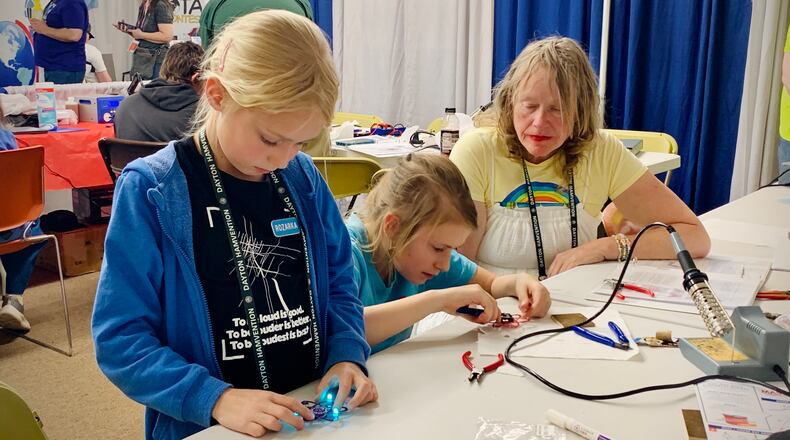 Two little girls from the Czech Republic construct FM radios at the 2025 Dayton Hamvention, Saturday May 17, 2025. LONDON BISHOP/STAFF