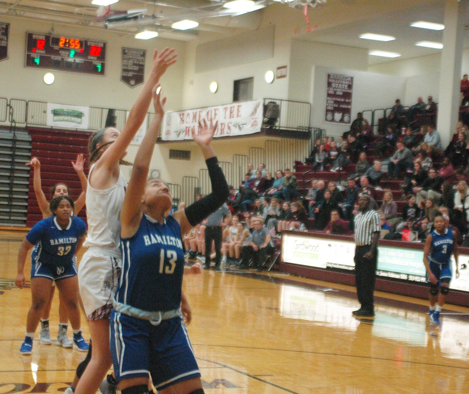 Lebanon’s Sid Rigsby reaches over Hamilton’s Jayden Isaacs (13) on a rebound attempt during Monday night’s game at Lebanon. Hamilton won 52-42. RICK CASSANO/STAFF