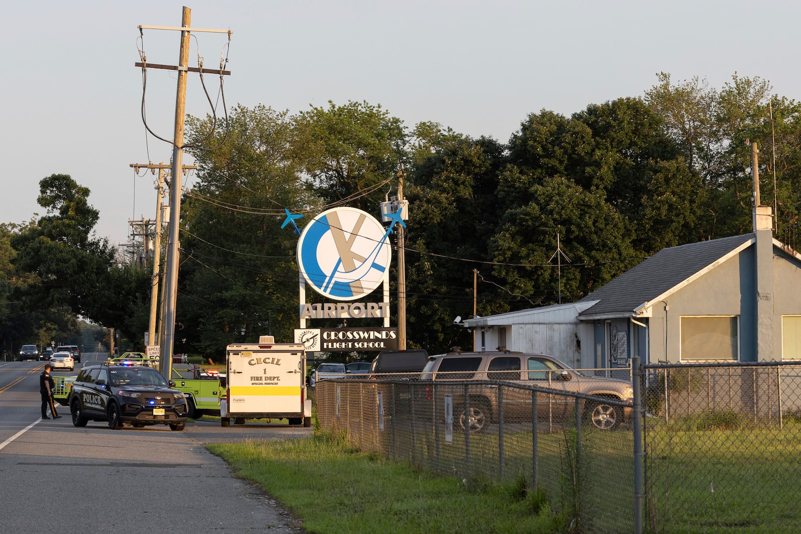 First responders work the scene at Cross Keys Airport in Gloucester County, N.J., after a skydiving aircraft went off the end of a runway and crashed into the woods Wednesday, July 2, 2025. (Kaiden J. Yu/The Philadelphia Inquirer via AP)