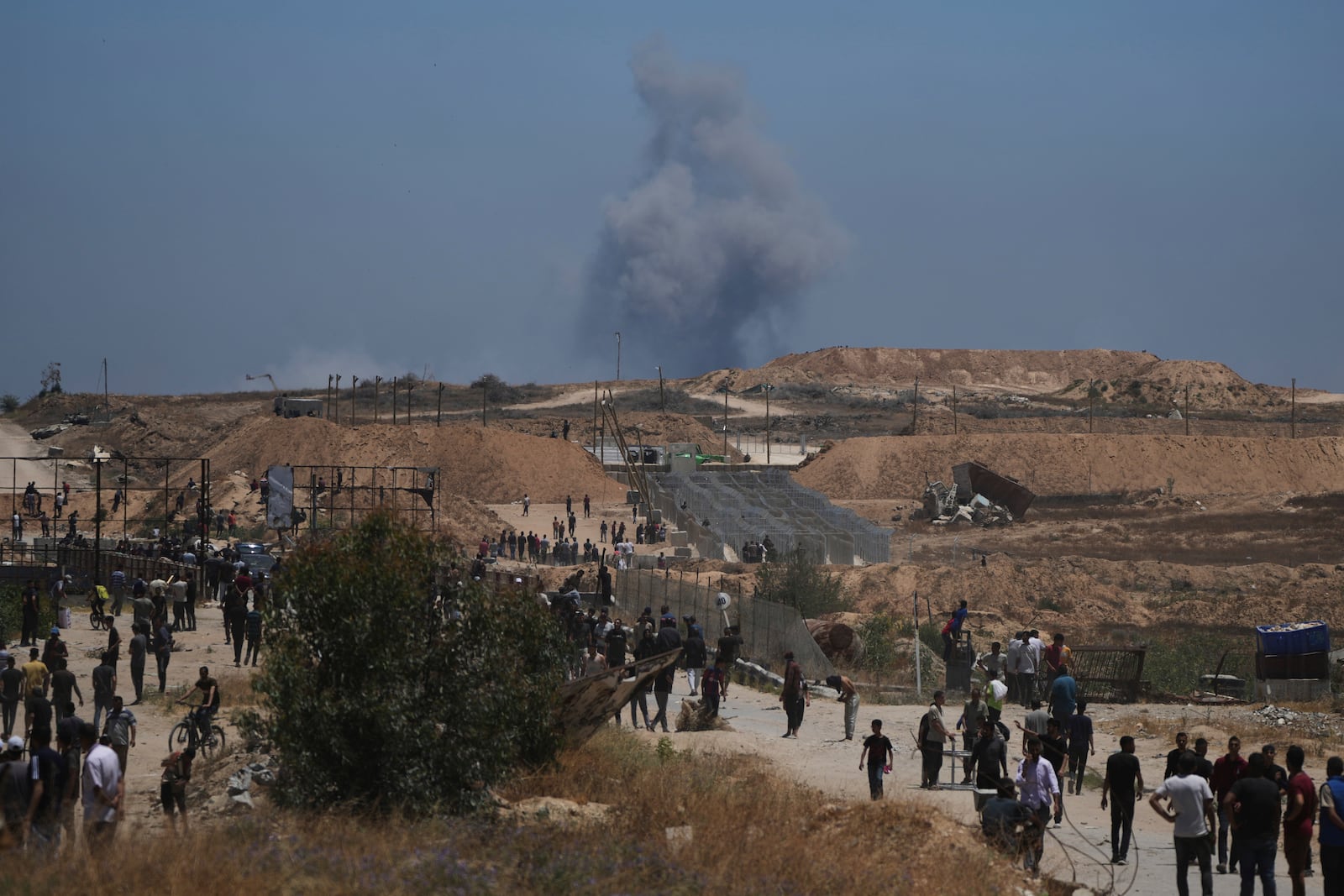 Smoke rises following an Israeli bombardment in southern Gaza, as seen from a humanitarian aid distribution center operated by the U.S.-backed Gaza Humanitarian Foundation, approved by Israel, in Khan Younis, southern Gaza Strip, on Thursday, May 29, 2025. (AP Photo/Abdel Kareem Hana)