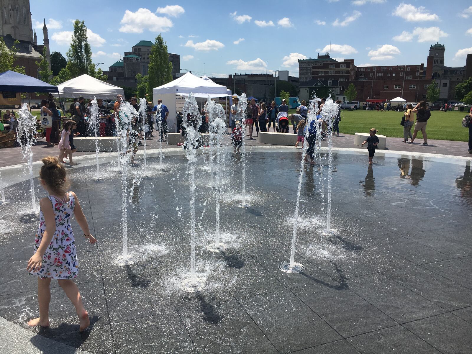 The splash pad was a favorite place for children to be during the Hamilton Flea’s opening day at Marcum Park Saturday. ED RICHTER/STAFF