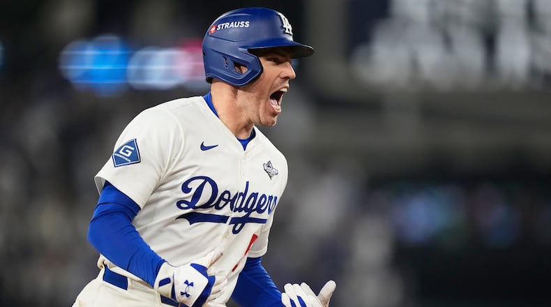 Los Angeles Dodgers' Freddie Freeman celebrates his walk off home run against the Toronto Blue Jays during the 18th inning in Game 3 of baseball's World Series, Monday, Oct. 27, 2025, in Los Angeles.(AP Photo/Brynn Anderson)