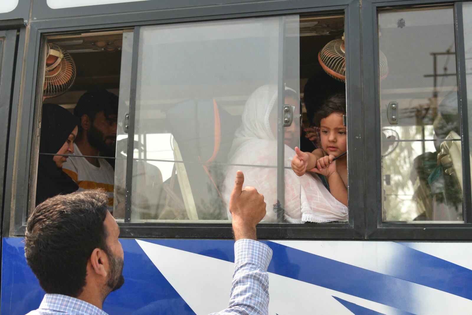 An Indian relative gives thumbs up to a Pakistani family as they leave in a bus at the Attari-Wagah border between India and Pakistan, near Amritsar, India, following New Delhi’s decision to order almost all Pakistani citizens to leave the country after last week’s deadly attack in Indian-controlled Kashmir, Wednesday, April 30, 2025. (AP Photo/Prabhjot Gill)