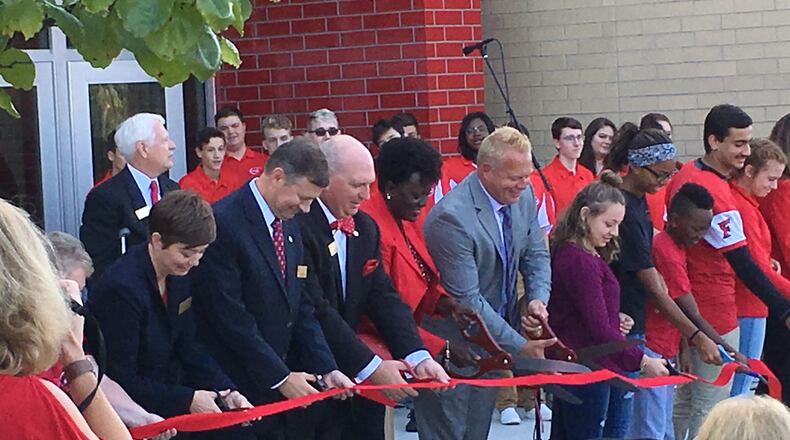 Students, staff and school board members participate in the official ribbon cutting ceremony at the new Fairfield Freshman School on Saturday, Sept. 9. The ribbon cutting was part of the dedication ceremonies for the community. ED RICHTER/STAFF