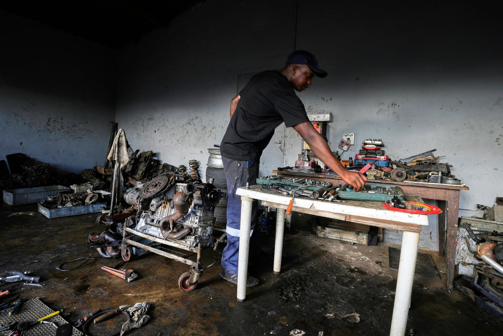 Themba Maseko, a 39-year-old mechanic, works inside his workshop in Brakpan, east of Johannesburg, South Africa, Wednesday, April 30, 2025. (AP Photo/Themba Hadebe)