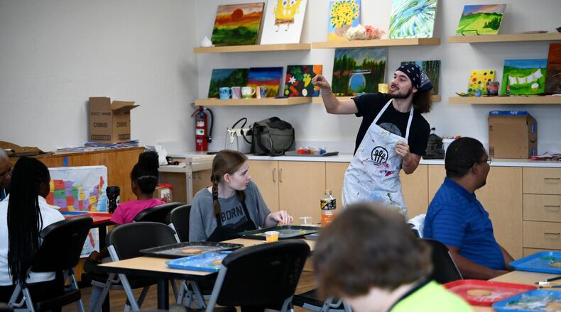 The artists at InsideOut Studio in Hamilton have worked with students at the Booker T. Washington Center for the past few summers thanks to funding from the Hamilton Community Foundation. Pictured is Cam Squire, a direct support professional at InsideOut and course instructor, provides instruction to the students and artists at the beginning of the arts class on mosaics at the BTW Center on Monday, July 7, 2025. MICHAEL D. PITMAN/STAFF