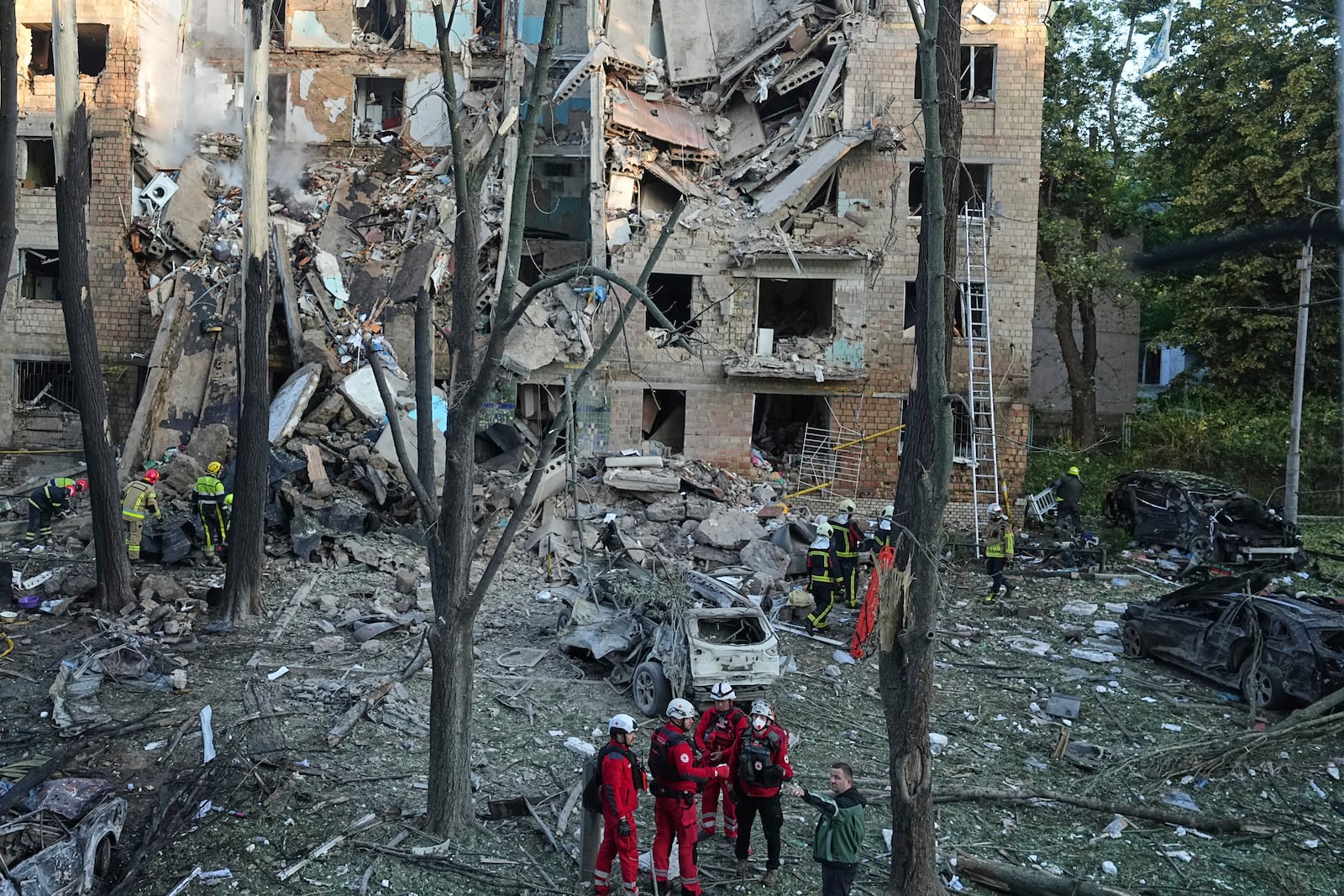 Firefighters work in a destroyed apartment building after a Russian attack in Kyiv, Ukraine, early Monday, June 23, 2025. (AP Photo/Efrem Lukatsky)