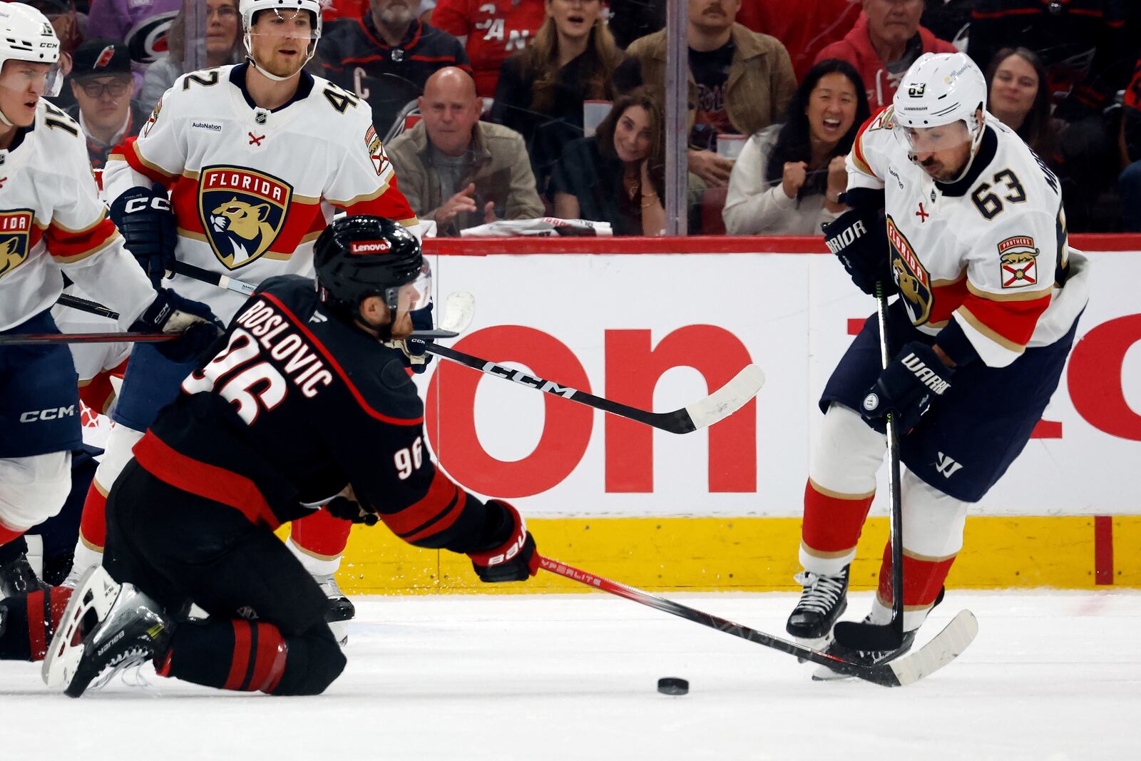 Florida Panthers' Brad Marchand (63) takes the loose puck away from Carolina Hurricanes' Jack Roslovic (96) during the first period of Game 2 of the NHL hockey Stanley Cup Eastern Conference finals in Raleigh, N.C., Thursday, May 22, 2025. (AP Photo/Karl DeBlaker)