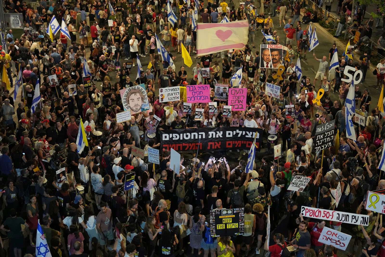 People take part in a protest demanding the end of the war and immediate release of hostages held by Hamas in the Gaza Strip, and against Prime Minister Benjamin Netanyahu's government in Tel Aviv, Israel, Saturday, June 28, 2025. (AP Photo/Ariel Schalit)