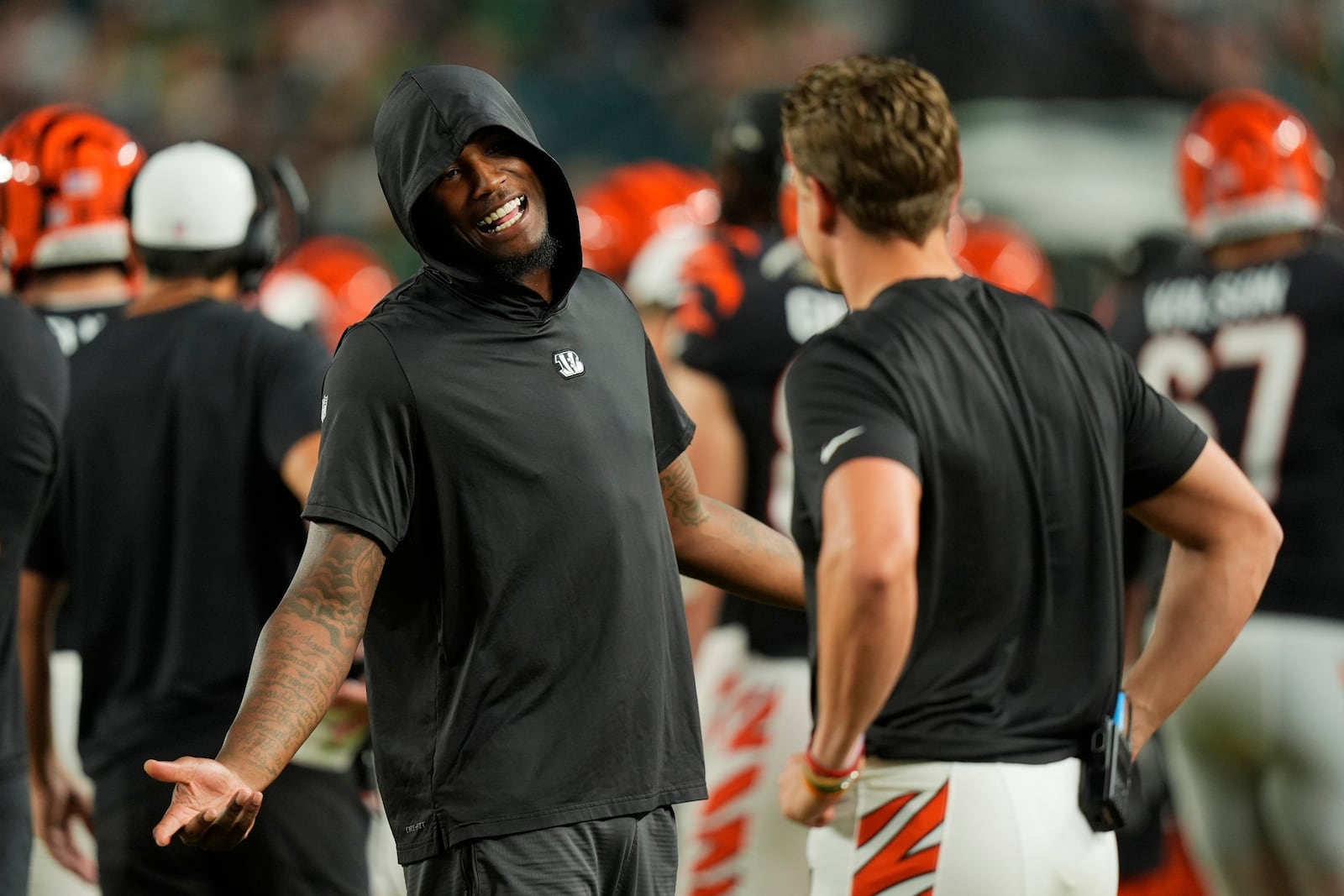 Cincinnati Bengals wide receiver Tee Higgins (5) talks to Cincinnati Bengals quarterback Joe Burrow (9) during the second half of an NFL preseason football game against the Philadelphia Eagles, Thursday, Aug. 7, 2025, in Philadelphia. (AP Photo/Chris Szagola, File)