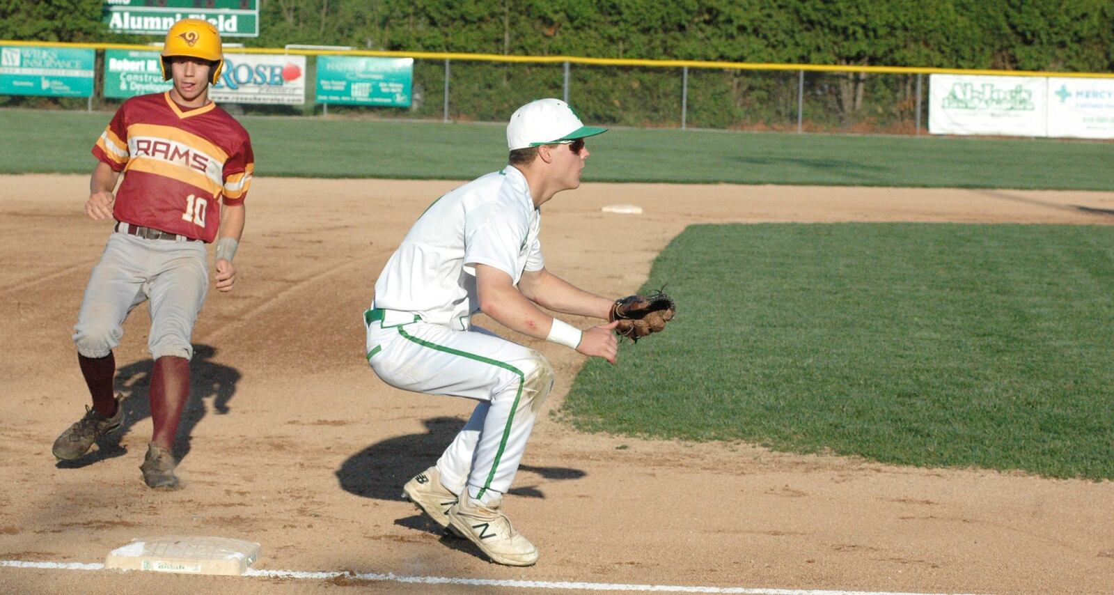 Cooper Shields of Ross comes to third base as Badin’s Evan Schlensker waits for the throw Monday night during a Butler County baseball game at Alumni Field in Joyce Park. Badin won 6-2. RICK CASSANO/STAFF