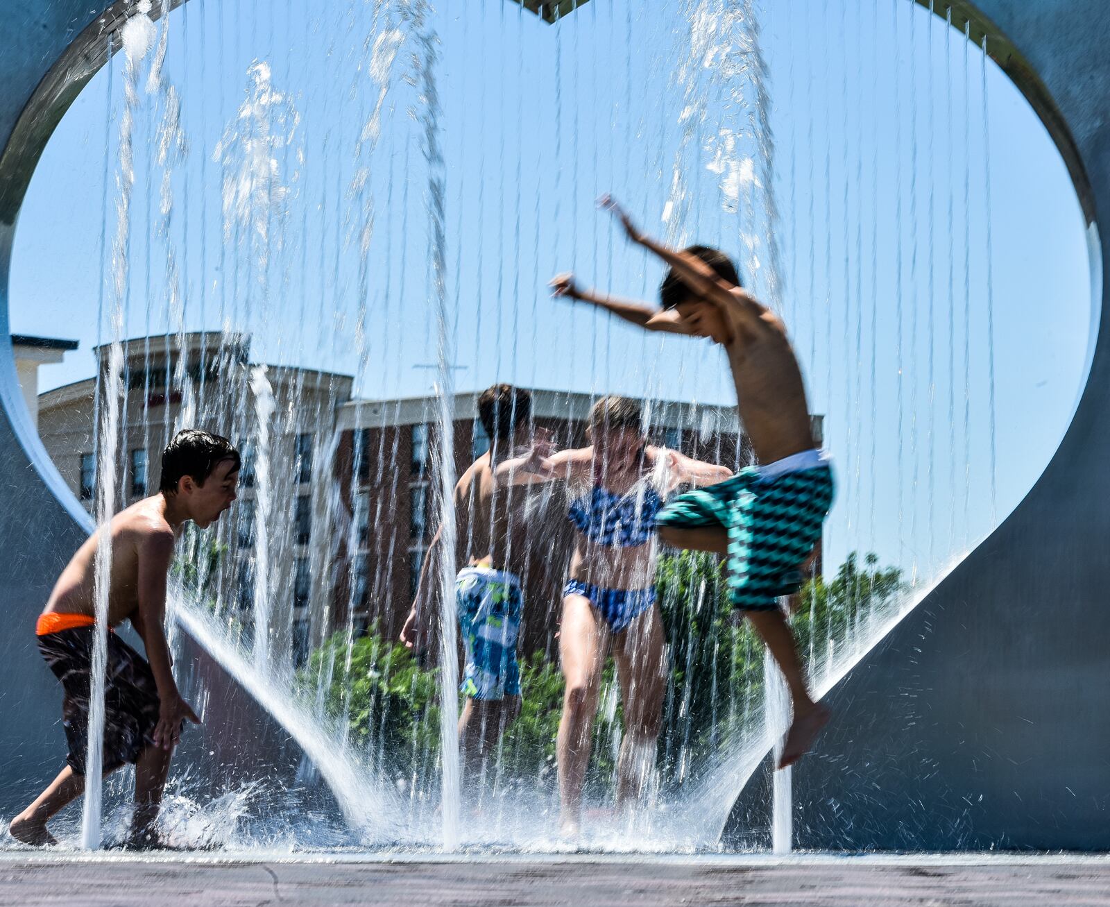 Kids play in the new fountain feature at Marcum Park in Thursday, June 6 in Hamilton. NICK GRAHAM/STAFF