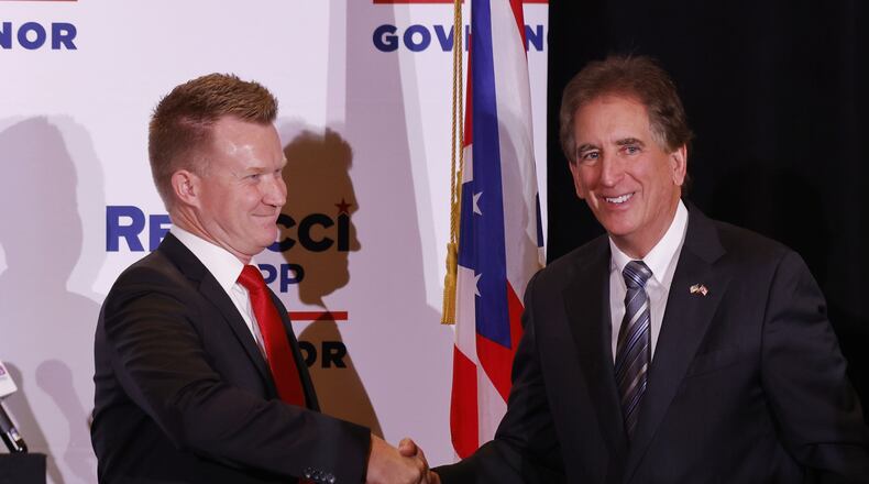 Springboro filmmaker Joe Knopp shakes hand with Ohio gubernatorial candidate Jim Renacci on Thursday, Dec. 2, 2021, at the Savannah Center in West Chester Twp. Renacci announced to a crowd of about 100 people Knopp will be his running mate. Renacci is challenging Ohio Gov. Mike DeWine in the May GOP primary. NICK GRAHAM/STAFF