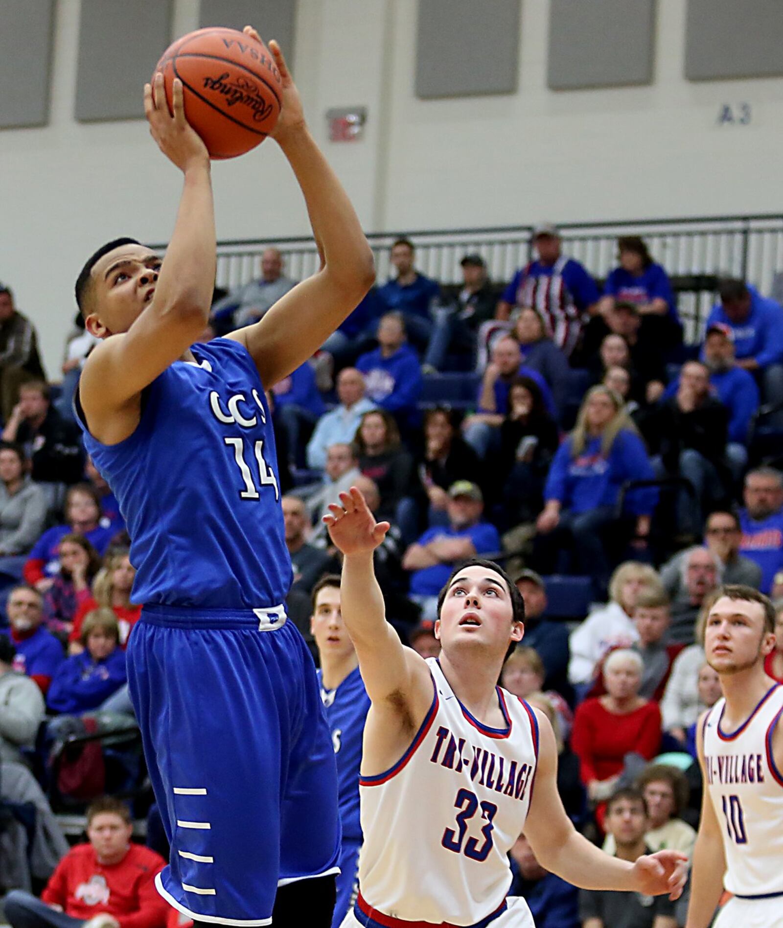 Cincinnati Christian’s Christian Keese gets past New Madison Tri-Village’s Christian Ricker (33) for a basket during Tuesday night’s Division IV regional semifinal at Fairmont’s Trent Arena. CONTRIBUTED PHOTO BY E.L. HUBBARD