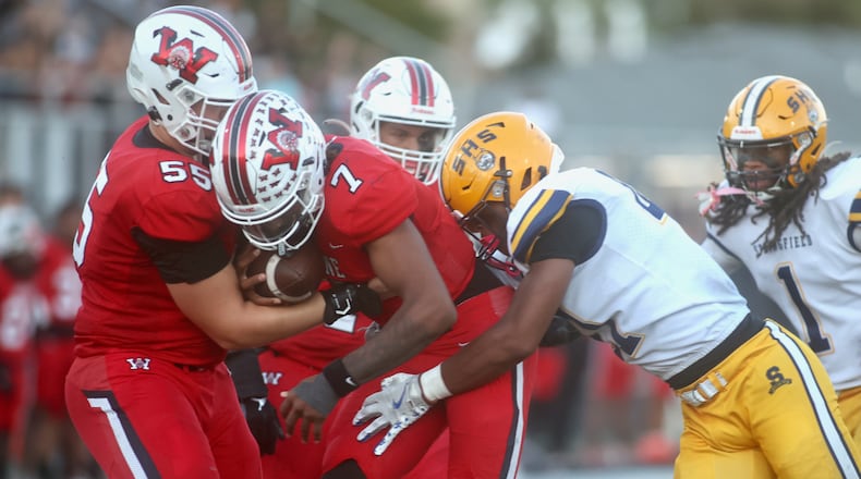 Springfield tackles Wayne's Kye Graham on Friday, Oct. 3, 2025, at Heidkamp Stadium in Huber Heights. David Jablonski/Staff