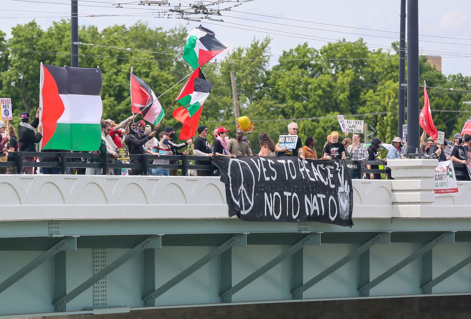 Protesters march around the security perimeter during the NATO Parliamentary Assembly in Dayton, Saturday, May 24, 2025. GREG LYNCH/STAFF