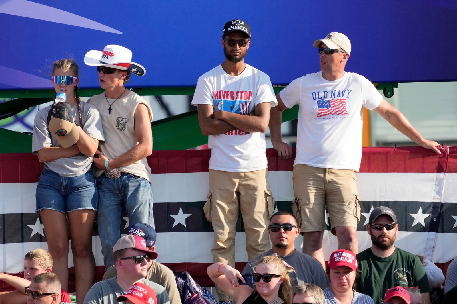 People listen before President Donald Trump arrives at a rally, Thursday, July 3, 2025, in Des Moines, Iowa. (AP Photo/Charlie Neibergall)