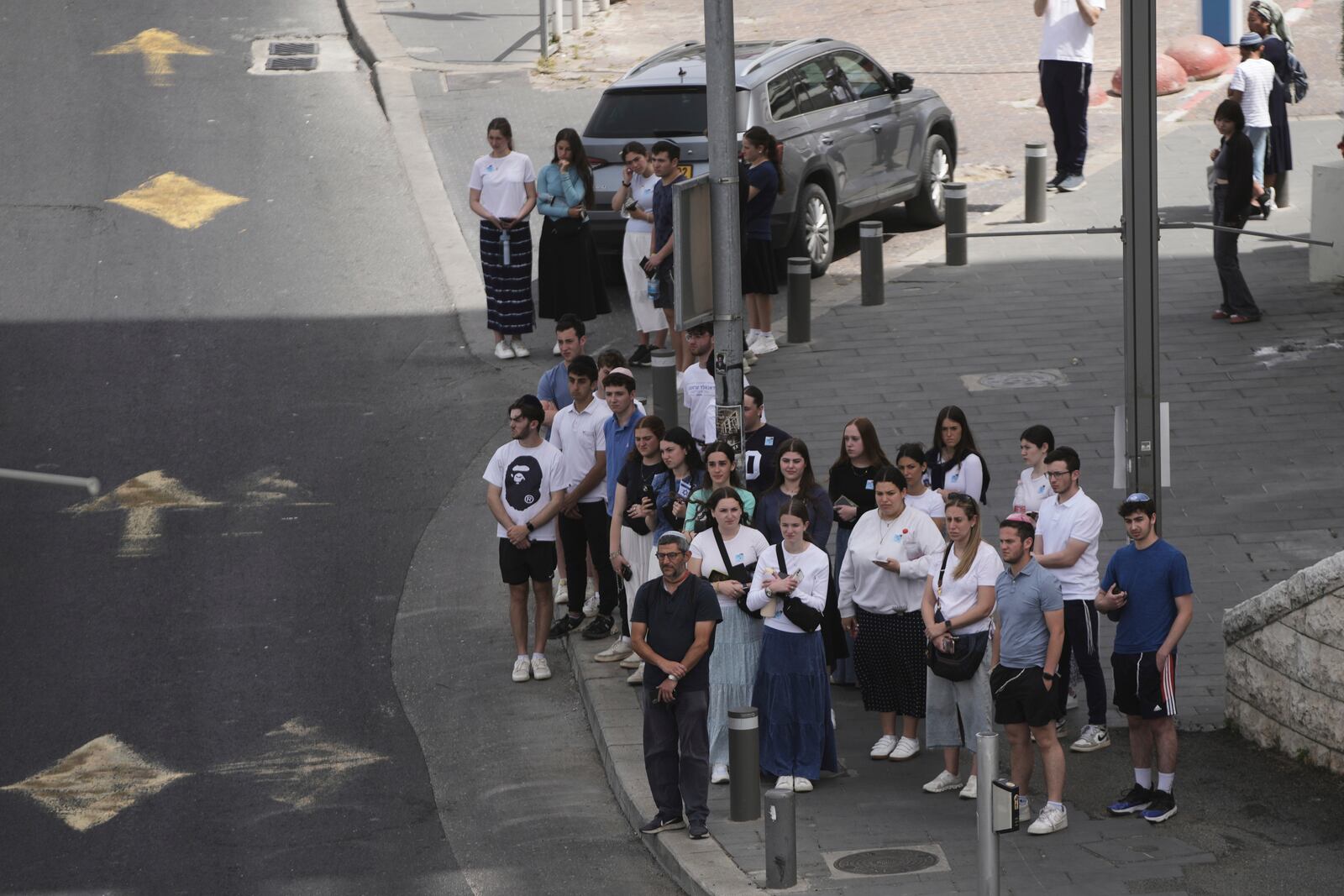 People stand still to observe two minutes of silence as air raid sirens sound marking the Israel's annual Memorial Day for the fallen soldiers and victims of nationalistic attacks in Jerusalem, Wednesday, April 30, 2025. (AP Photo/Mahmoud Illean)