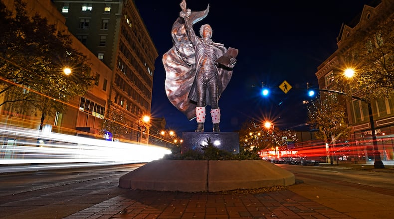 Car lights are blurred during a 20-second exposure of The American Cape sculpture of Alexander Hamilton, by metal sculptor Kristen Visbal, as cars drive by on High Street in Hamilton. NICK GRAHAM/STAFF