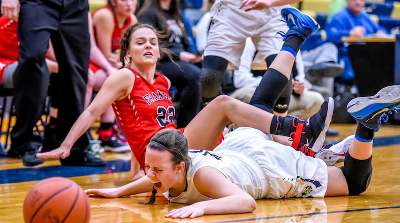 Franklin's Jessica King (22) and Monroe's Katie Sloneker fall to the ground as they fight for a ball during their game Thursday, Dec. 15 at Monroe High School in Monroe. NICK GRAHAM/STAFF