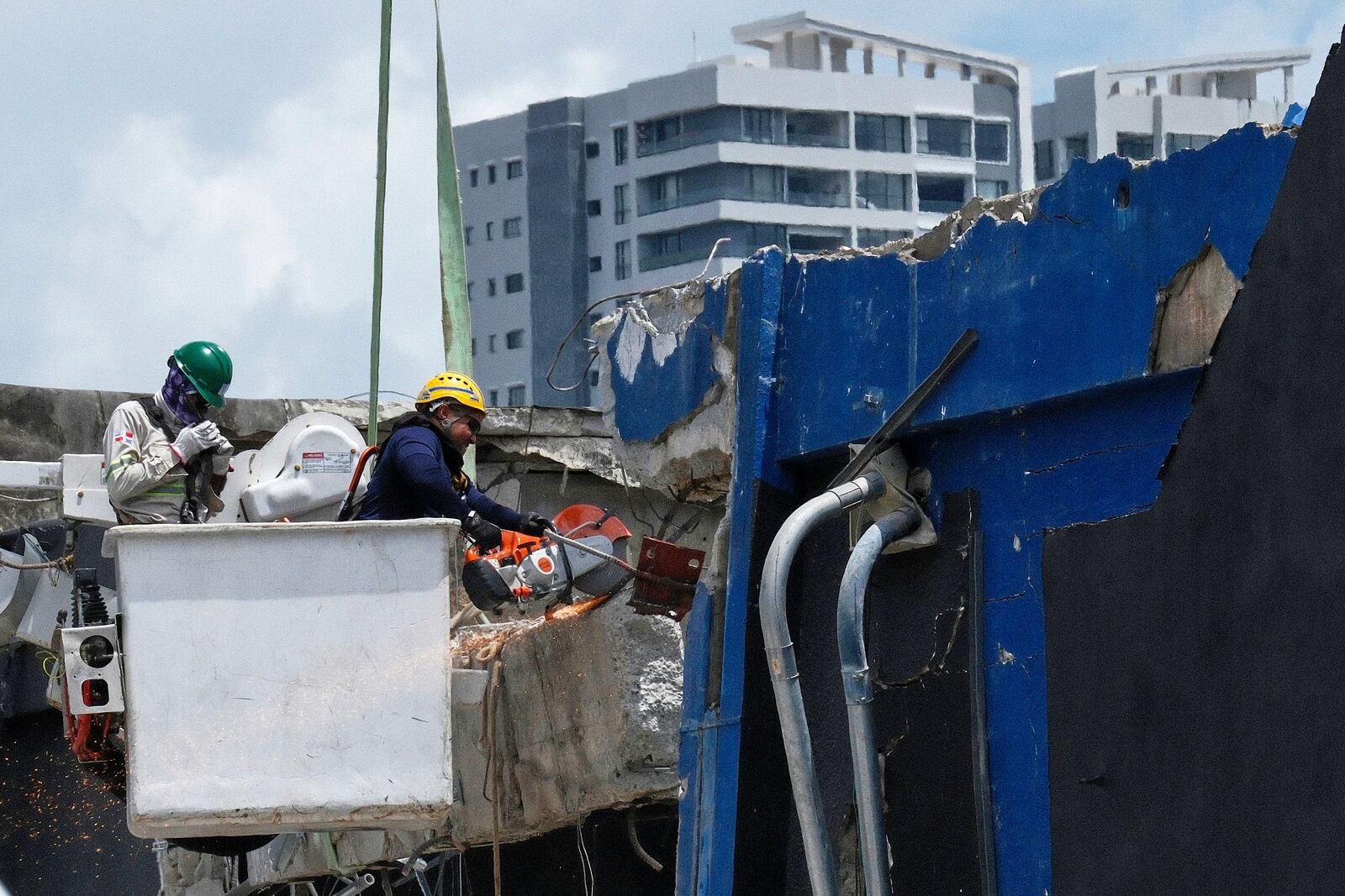 Rescue workers cut a wall while searching for survivors at the Jet Set nightclub after its roof collapsed two days prior during a merengue concert in Santo Domingo, Dominican Republic, Wednesday, April 9, 2025. (AP Photo/Ricardo Hernandez)