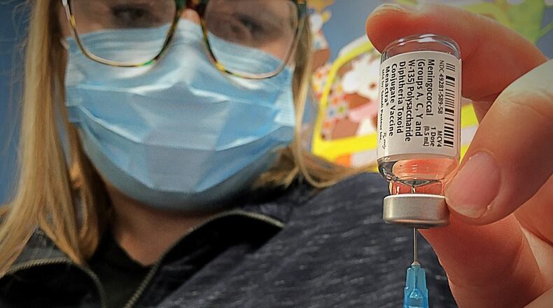 Britney Evans, RN, prepares to give a vaccine Friday, at PriMED Springboro Pediatrics, located at the Dayton Children's South Campus. The practice is continuing to reach out to parents and patients to encourage them to schedule, after health care visits fell early in the pandemic. MARSHALL GORBY\STAFF