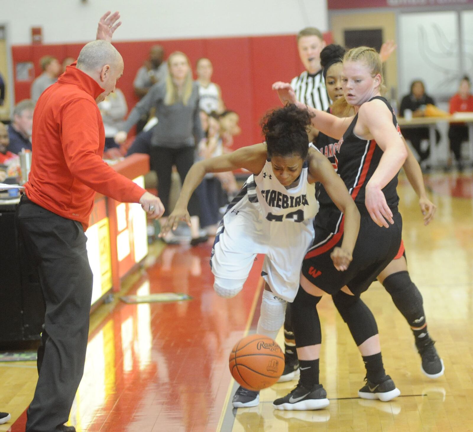 Coach Andy Fishman (left) and Abby Prohaska (right) of Lakota West watch Fairmont’s Makira Webster lose control of the ball on the sideline during Saturday afternoon’s Division I district final at Princeton. MARC PENDLETON/STAFF