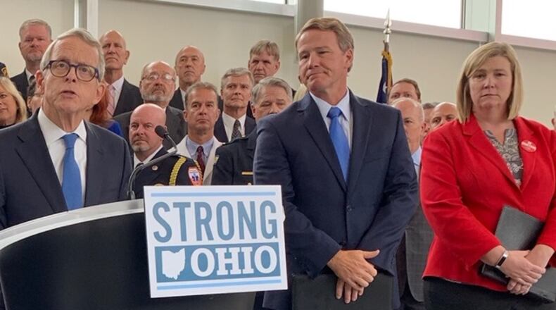 Gov. Mike DeWine announces his Strong Ohio gun bill plan Monday, Oct. 7 in Columbus. Lt. Gov. Jon Husted and Dayton Mayor Nan Whaley are to his right. Photo by Laura Bischoff