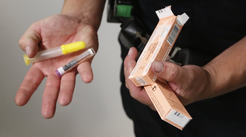 An area police officer replenishes his supply of Narcan. The drug aims to prevent opioid overdoses when administered to people in that situation. CHRIS STEWART / FILE PHOTO