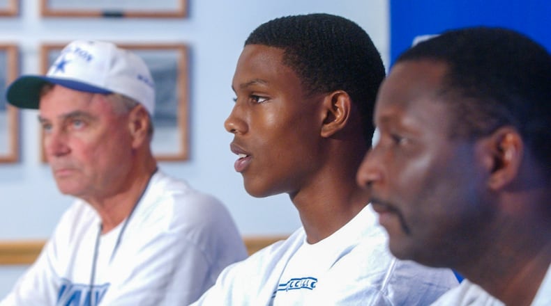 Hamilton High School football standout Brandon Underwood, center, announced that he will play for Ohio State University after he graduates next spring. He made the announcement Wednesday evening at the high school. With him are Big Blue football coach Jerry Scrivner, left, and head coach Eric Gillespie.
JOHN JANCO/JOURNALNEWS