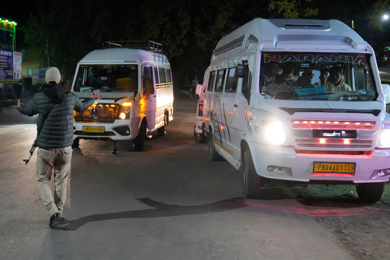 An Indian police officer stops a tourist vehicle near Pahalgam in south Kashmir after assailants indiscriminately opened fired at tourists visiting Pahalgam, Indian controlled Kashmir, Tuesday, April 22, 2025.(AP Photo/Dar Yasin)