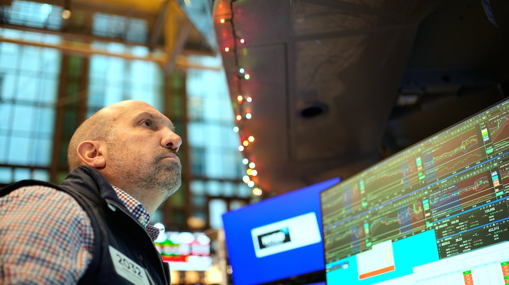 James Denaro works on the floor at the New York Stock Exchange in New York, Wednesday, Dec. 10, 2025. (AP Photo/Seth Wenig)