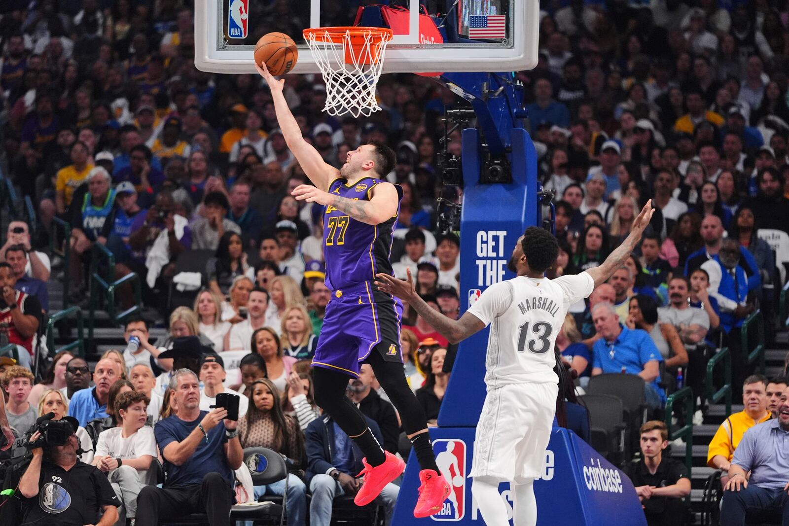 Los Angeles Lakers' Luka Doncic (77) shoots as Dallas Mavericks' Naji Marshall (13) defends in the first half of an NBA basketball game in Dallas, Wednesday, April 9, 2025. (AP Photo/LM Otero)